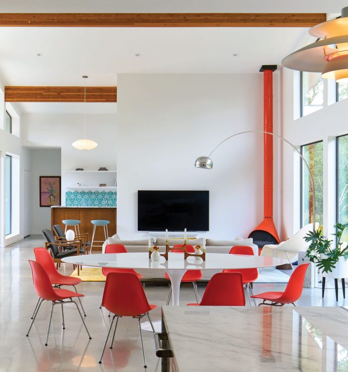 Midcentury living room with high ceilings and red furniture
