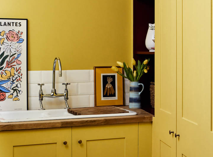 Mustard yellow cabinetry and walls painted with Mylands Haymarket No. 47 from the Colours of London collection, the perfect palette for picking paint colors.