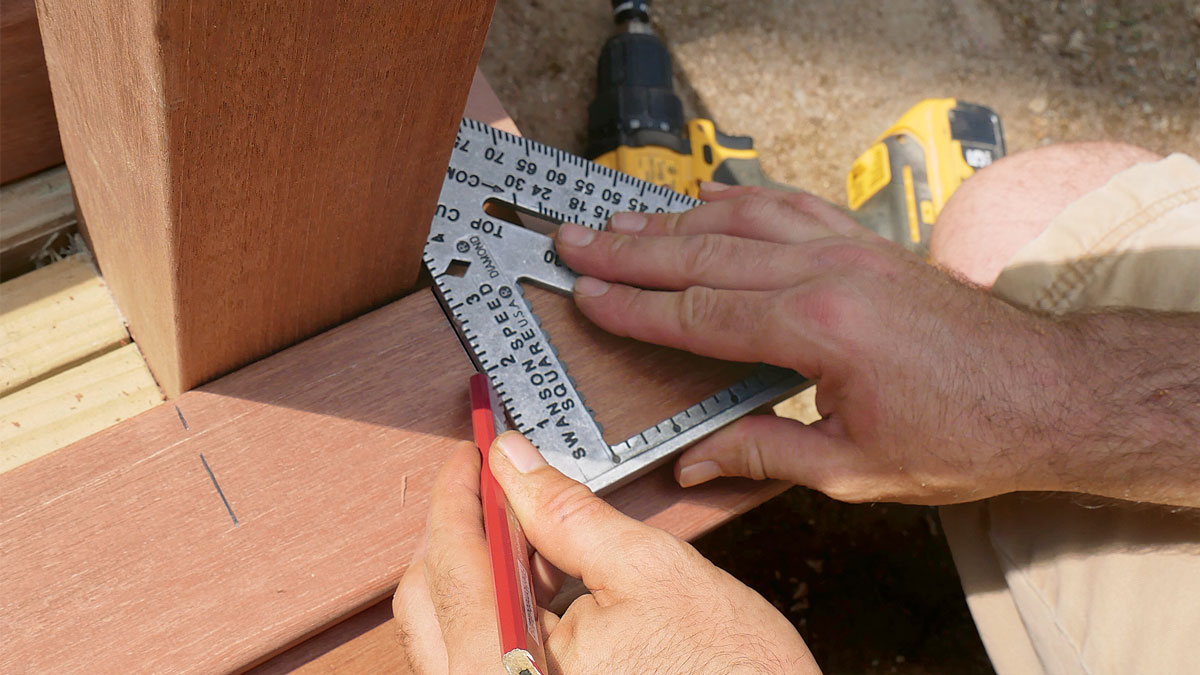 Notch for posts. Use a speed square to transfer post locations to the tread boards of the bottom step. Cut the notch with a jigsaw and round over the cuts.