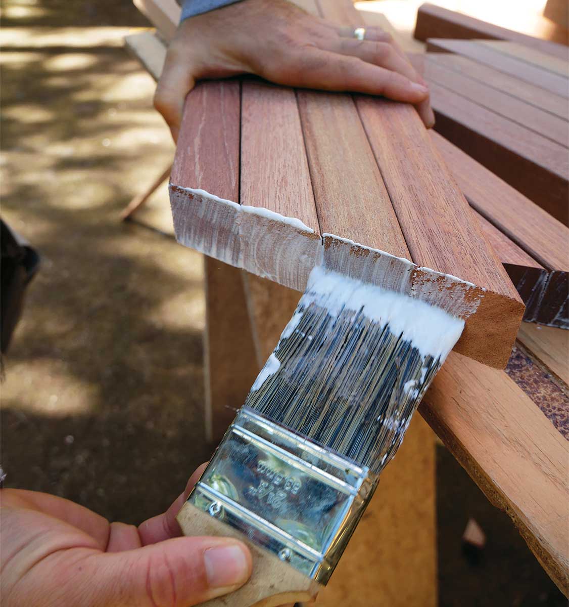 Bevel and seal the balusters. Cut the balusters to length (these balusters are 30 in. for a total 36-in.-high railing) using the same miter-saw setting used to bevel the rails. Butter the cut ends with a wax emulsion to prevent the end grain from taking on water, leading to rot.