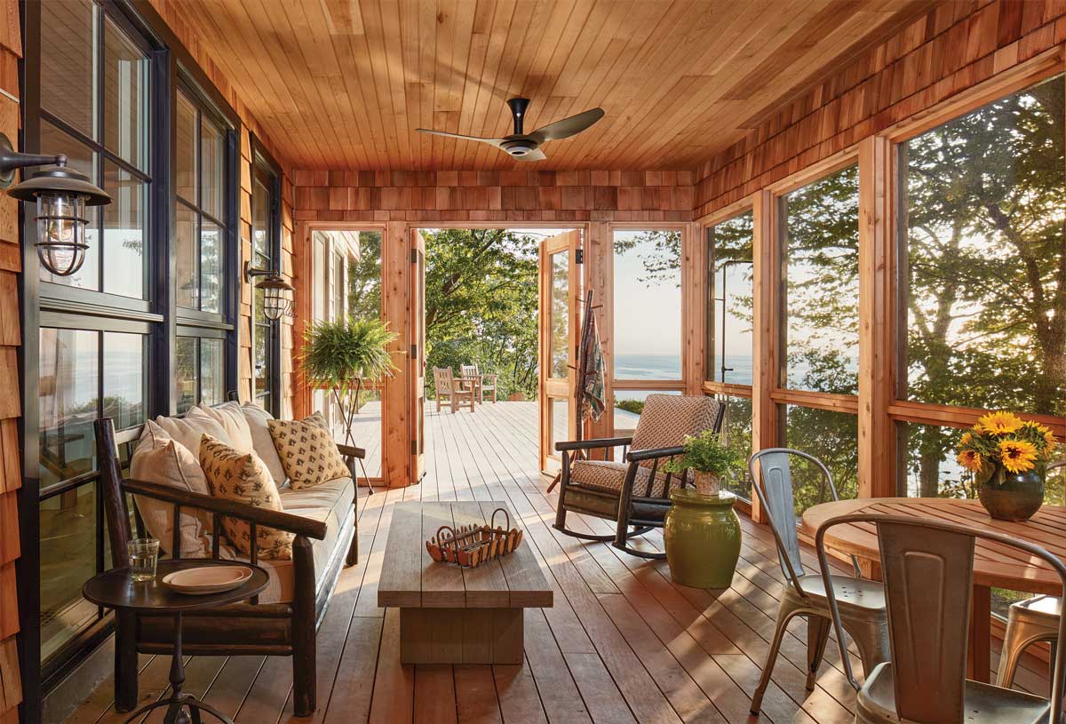 Large porch with furniture and open door to lake views