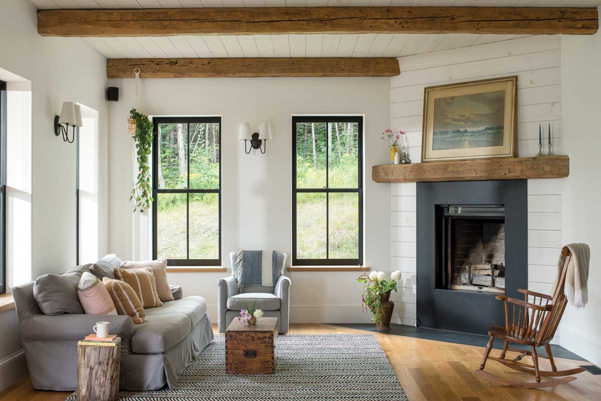 living room with large windows and exposed beams