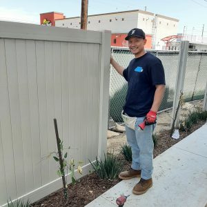 Brian Alvarado with a fence he helped build