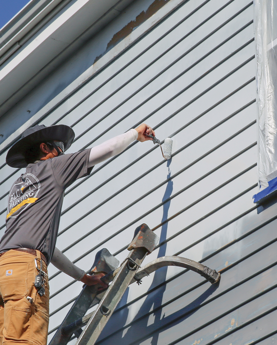 Rollers work in tight areas. We like mini rollers, which allow you to paint close to trim, at the bottom of lap siding, and in other tight corners.