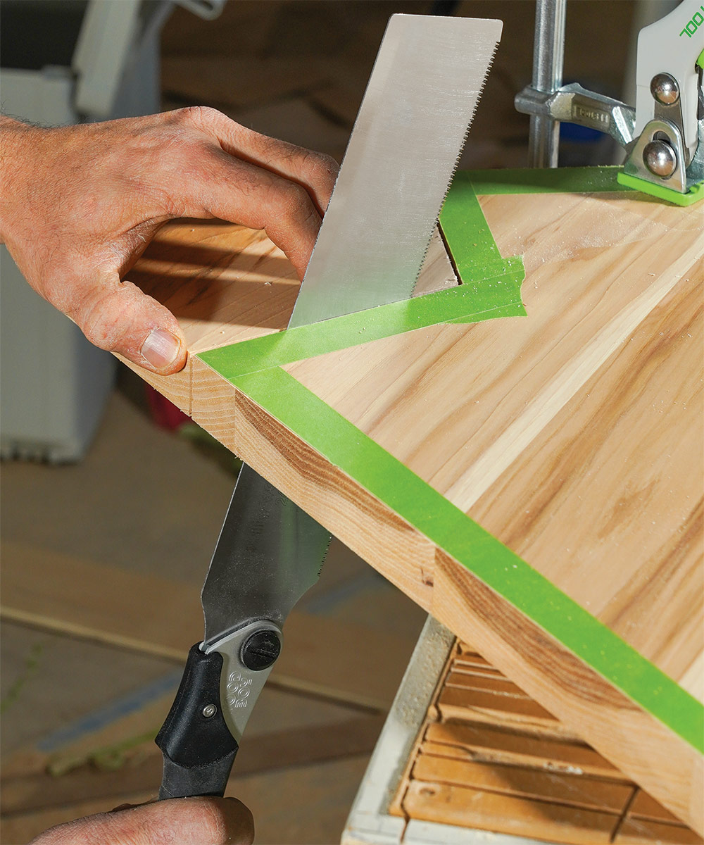 using a Japanese-style pullsaw to cut out the shelf shape