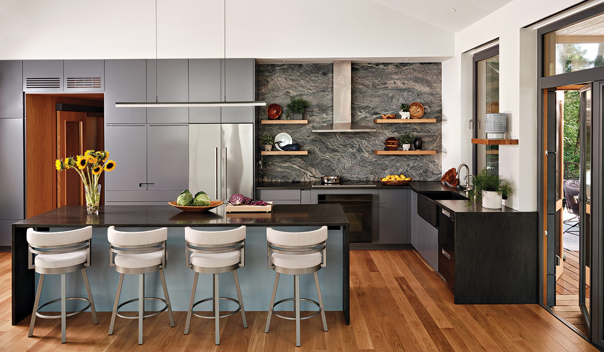 kitchen with grey cabinets and black countertops and island