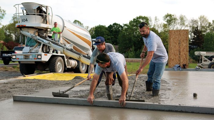 crew members laying out cement 