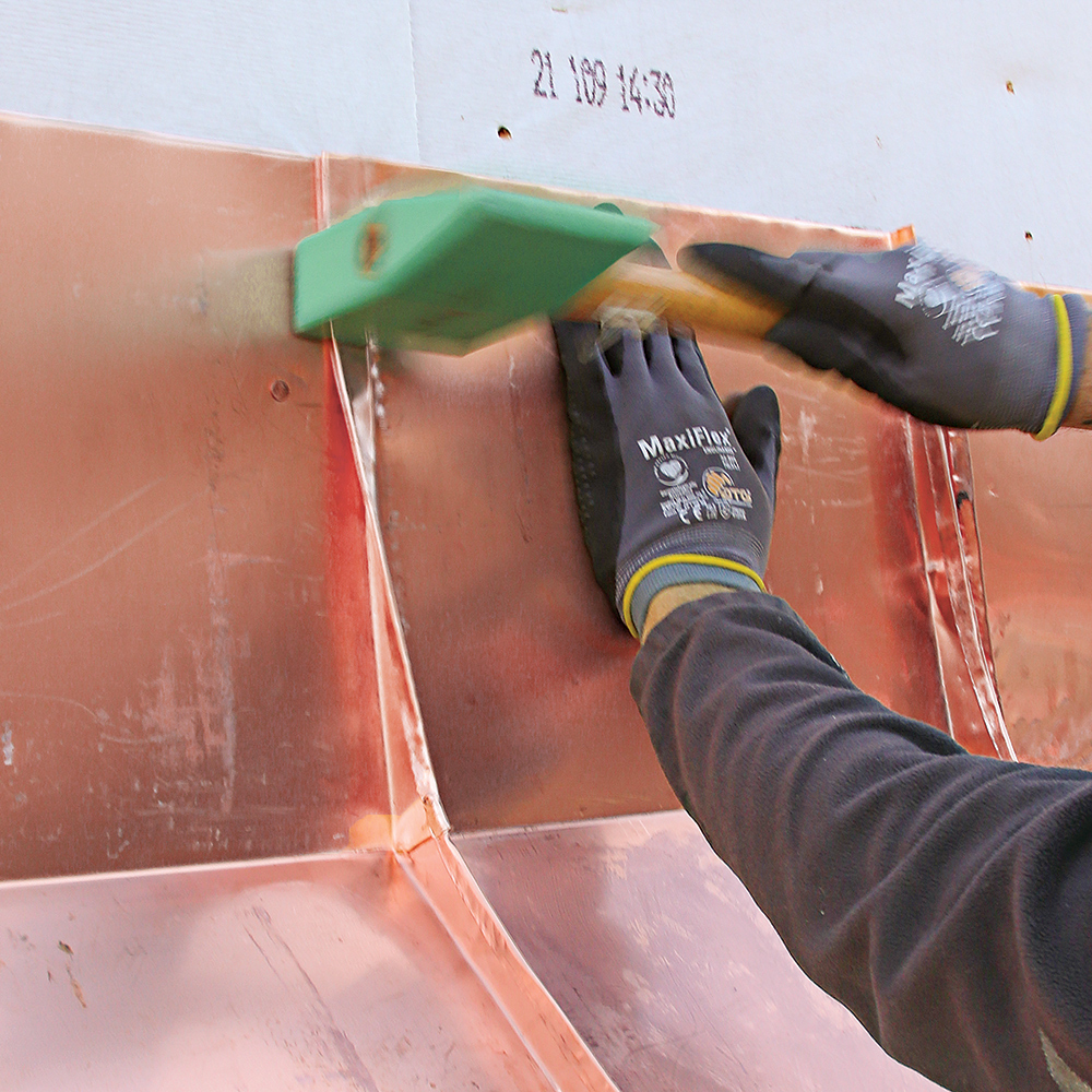 flatten the seam where the copper panels meet the wall 