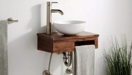 Brown vessel-sink vanity with a cutout for a towel