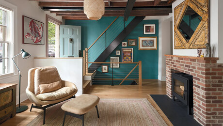 living room with fireplace with door entryway and staircase