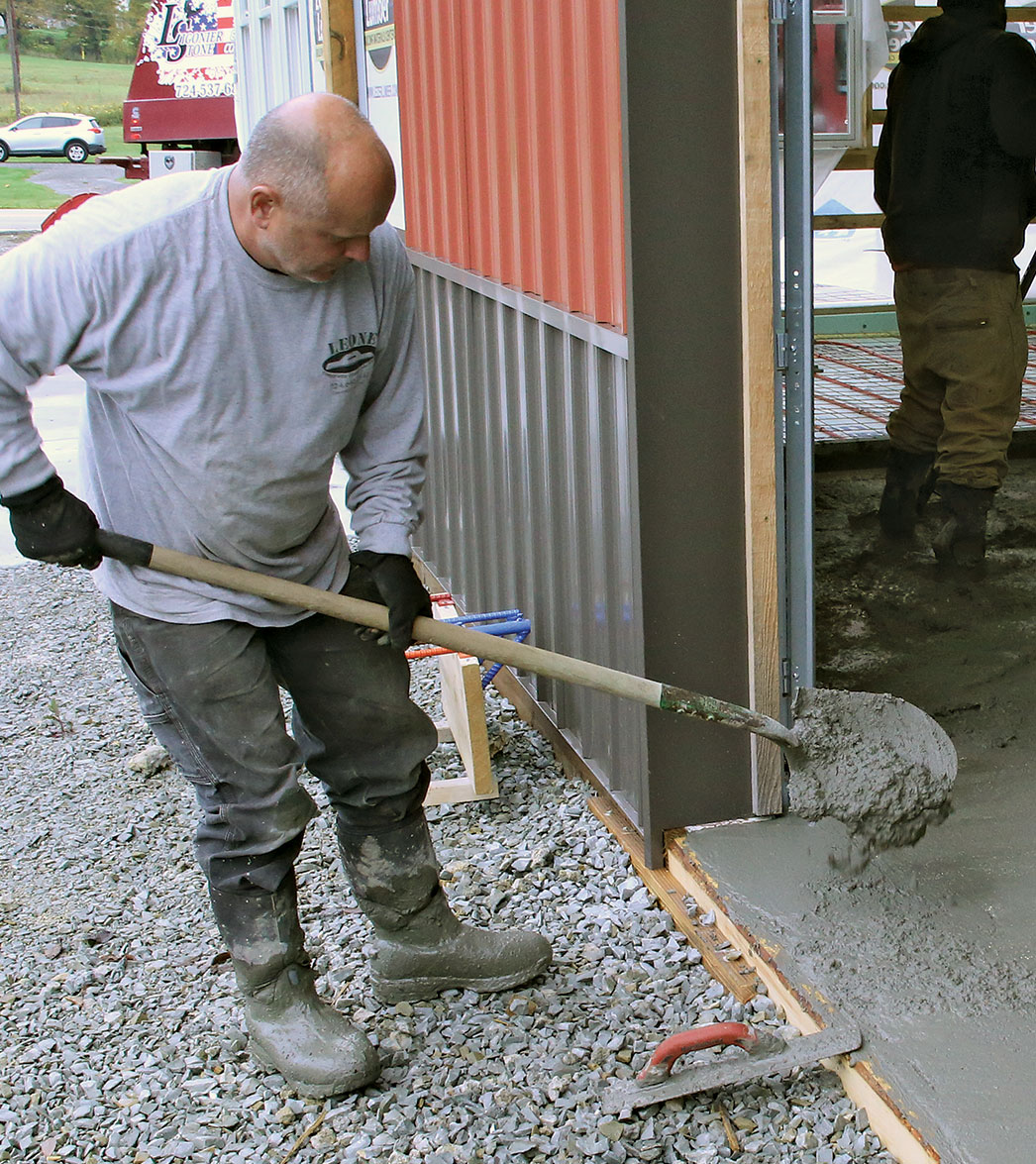 Fill low spots A shovelful or two of concrete fills low spots. Areas near door openings and around pipes and support columns are common low spots because these jogs and interruptions interfere with the screeding process.
