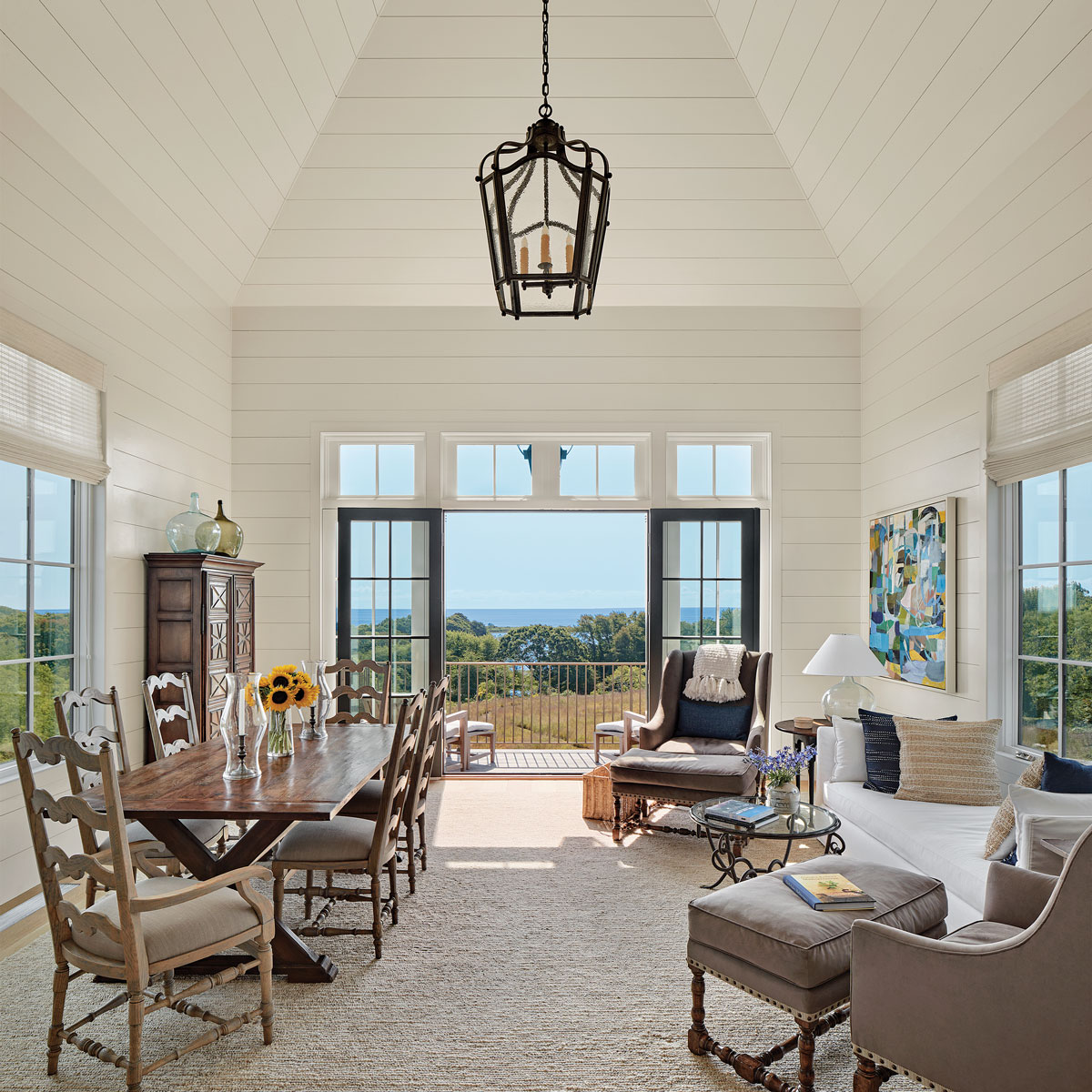 living room with door open facing an ocean view