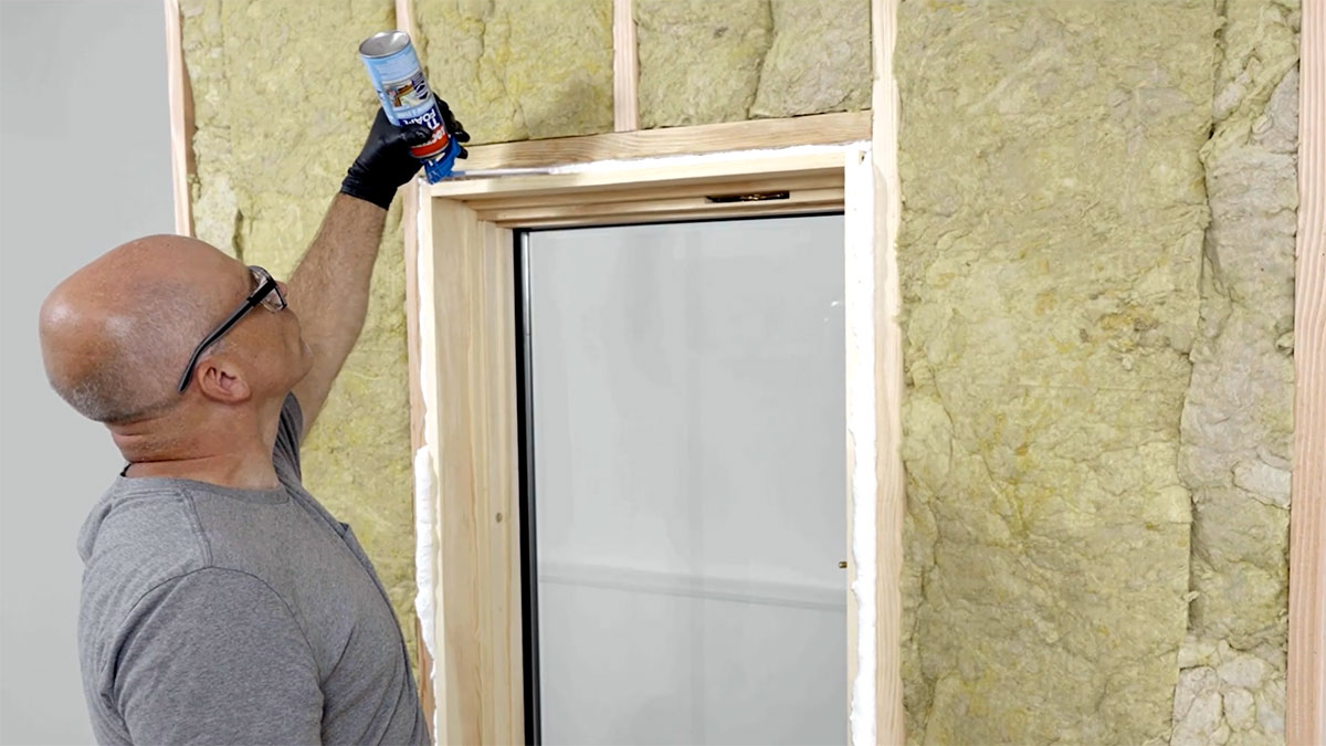 Applying Loctite insulating foam to a window