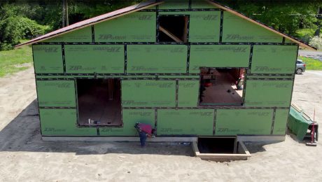 A man working on the mudsill of a house that has Zip sheathing