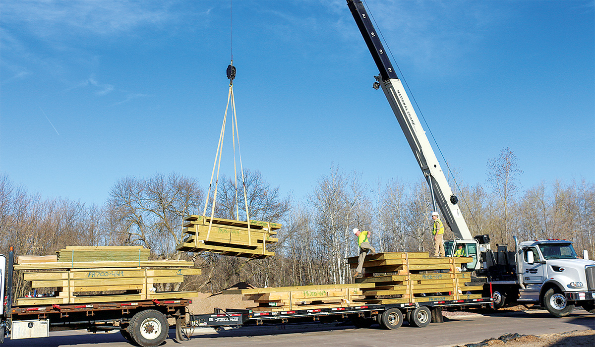 8-ft.-tall foundation wall panels being delivered on a flat-bed trailer