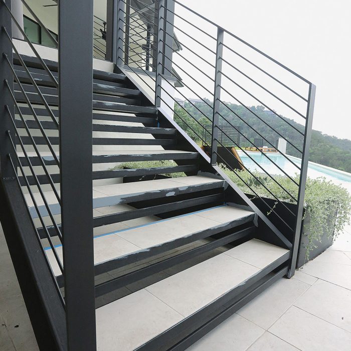 Photo of a deck stairs built using noncombustible materials like stucco, steel, and fiber-cement.