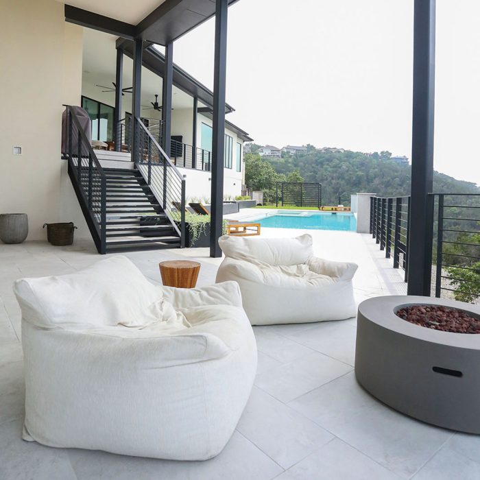 Photo of a pool deck built using noncombustible materials like stucco, steel, and fiber-cement.