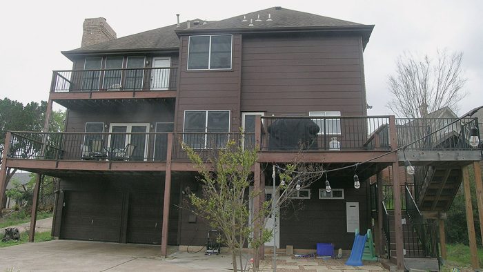 Photo of a brown, 3-story home before renovation.