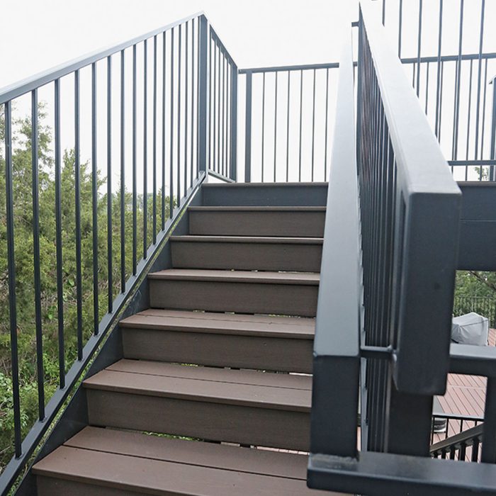 Photo of stairs on a back deck addition built using noncombustible materials like brick. steel, and fiber-cement siding.