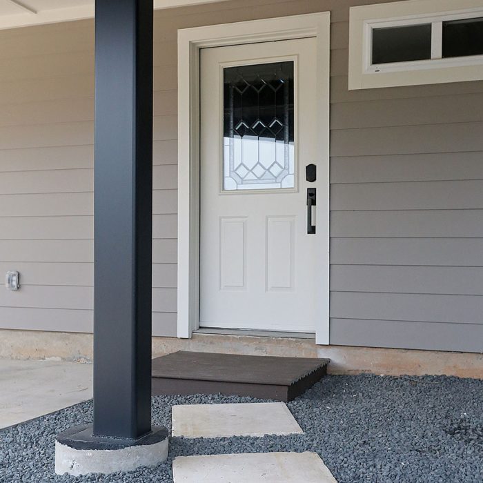 Photo of the bottom of a back deck addition built using noncombustible materials like brick. steel, and fiber-cement siding.