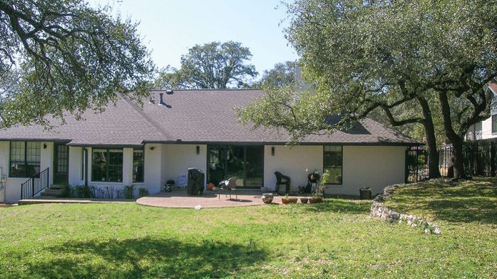 Photo of a white ranch-style home before renovation.