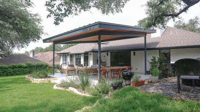 Photo of a white ranch-style home after renovation with an outdoor living space addition made of cumaru hardwood, metal, and more.