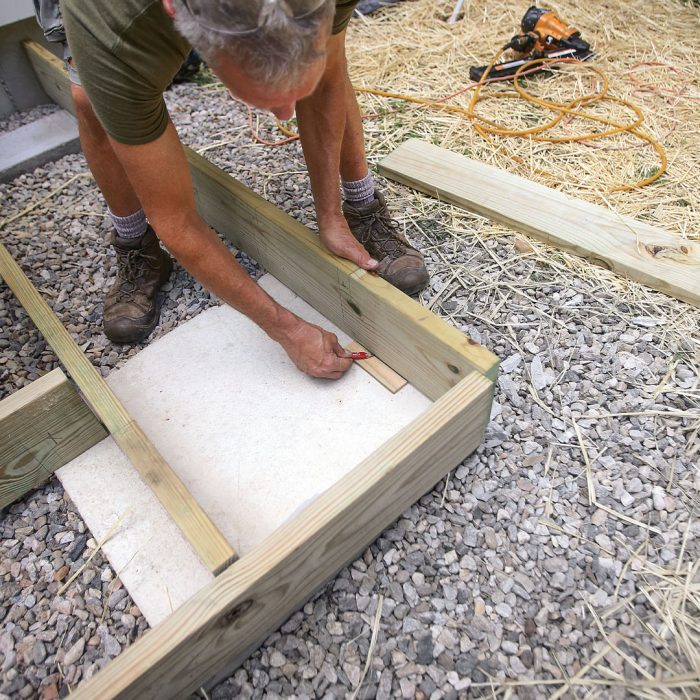 Man scribes a cut line with a scrape of wood of the right thickness.